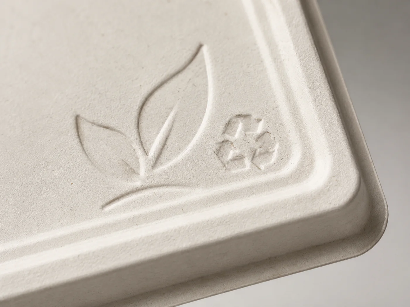 Custom embossed logo detail on a molded bagasse food tray