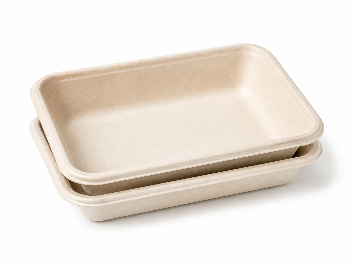 Compact bagasse produce trays nested on white background