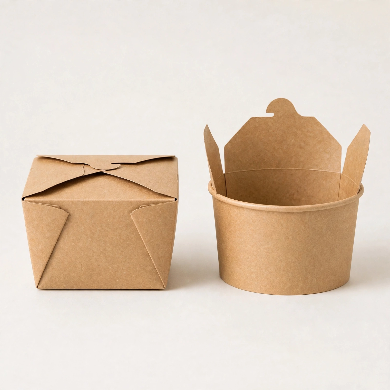Closed square-bottom noodle box next to an open round-bottom paper tub